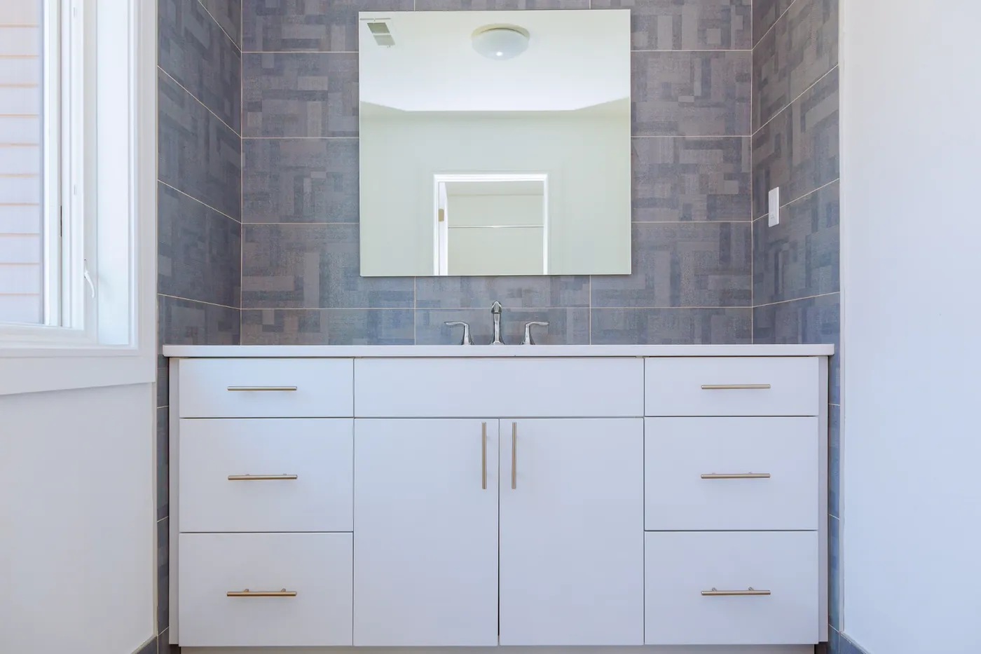 Custom bathroom vanity with sink and mirror in an Austin home