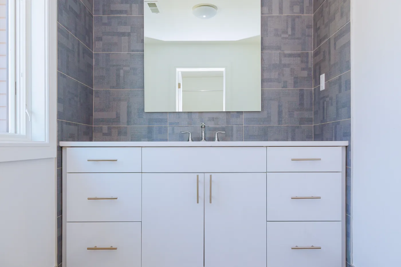 Bathroom vanity with a sink and mirror in a finished bathroom