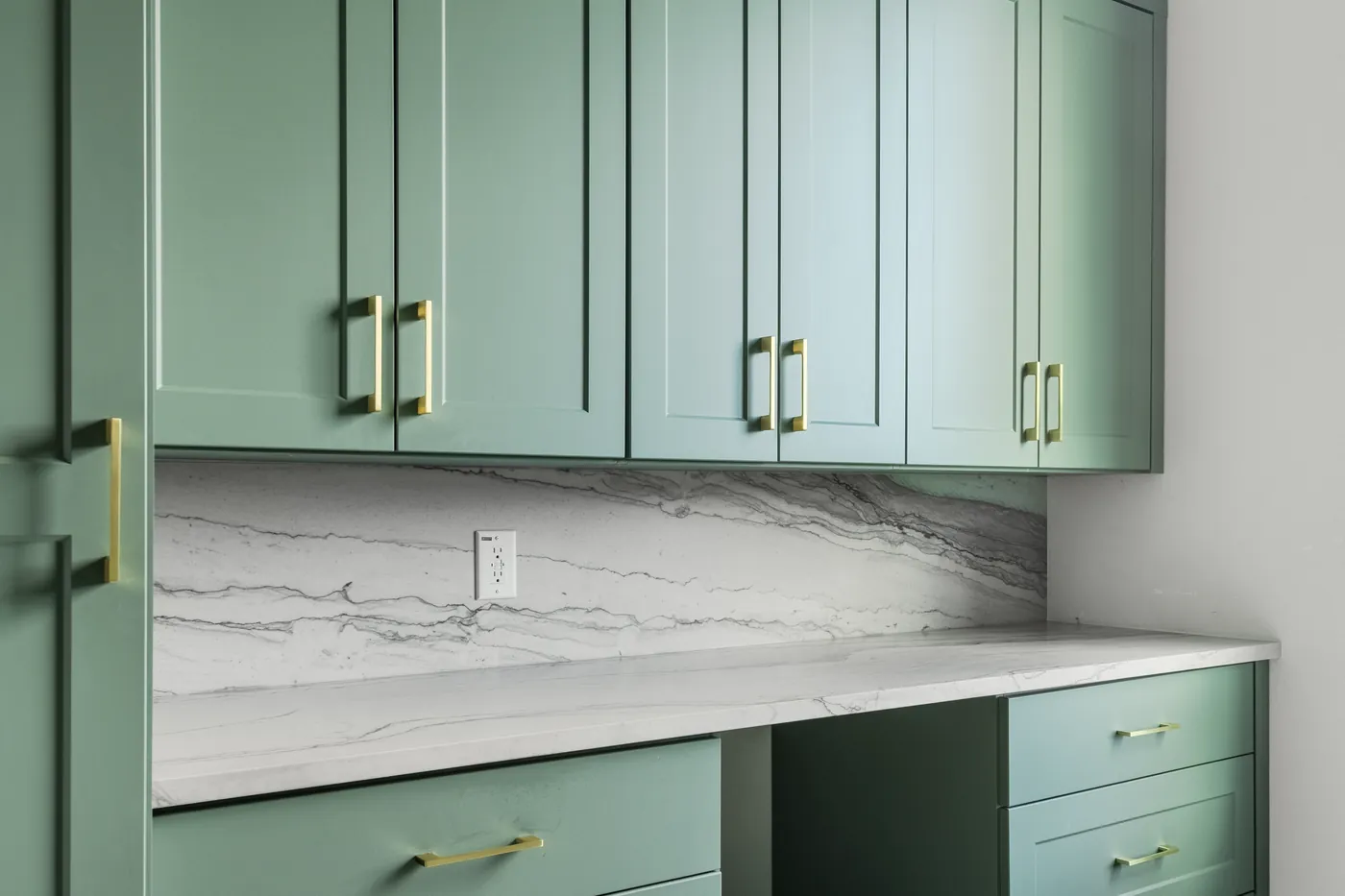 Green cabinetry with brass pulls and a marble counter, the doors and hardware a refacing job replaces