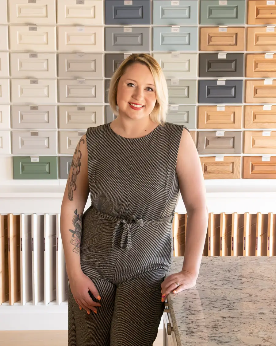 Savannah Hargett at a wall of cabinet door styles and finish samples
