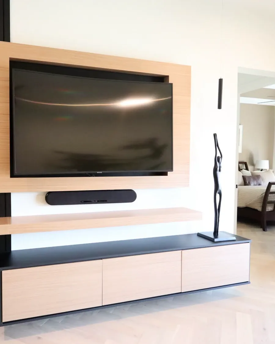 Custom media wall with a floating console, slatted timber panel and recessed television