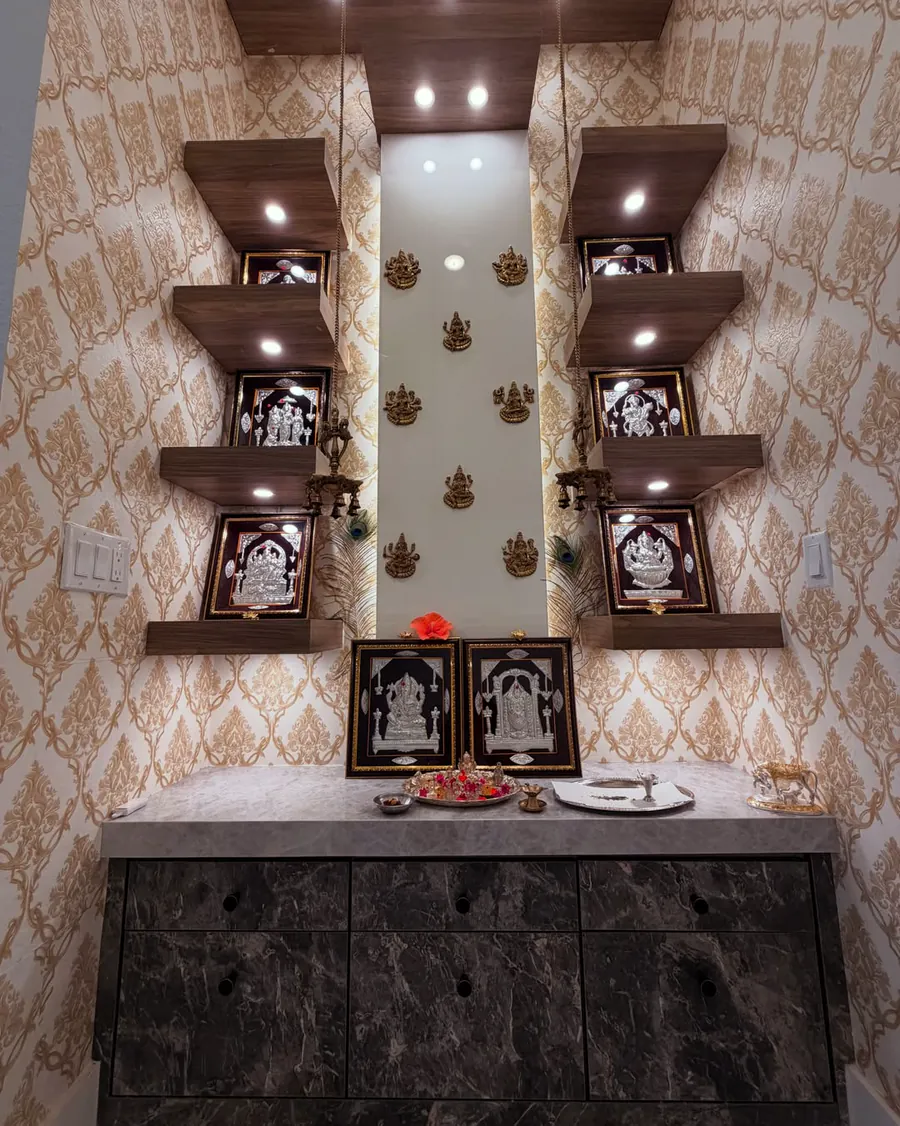 Custom pooja room with lit timber display shelves and a stone-faced base cabinet