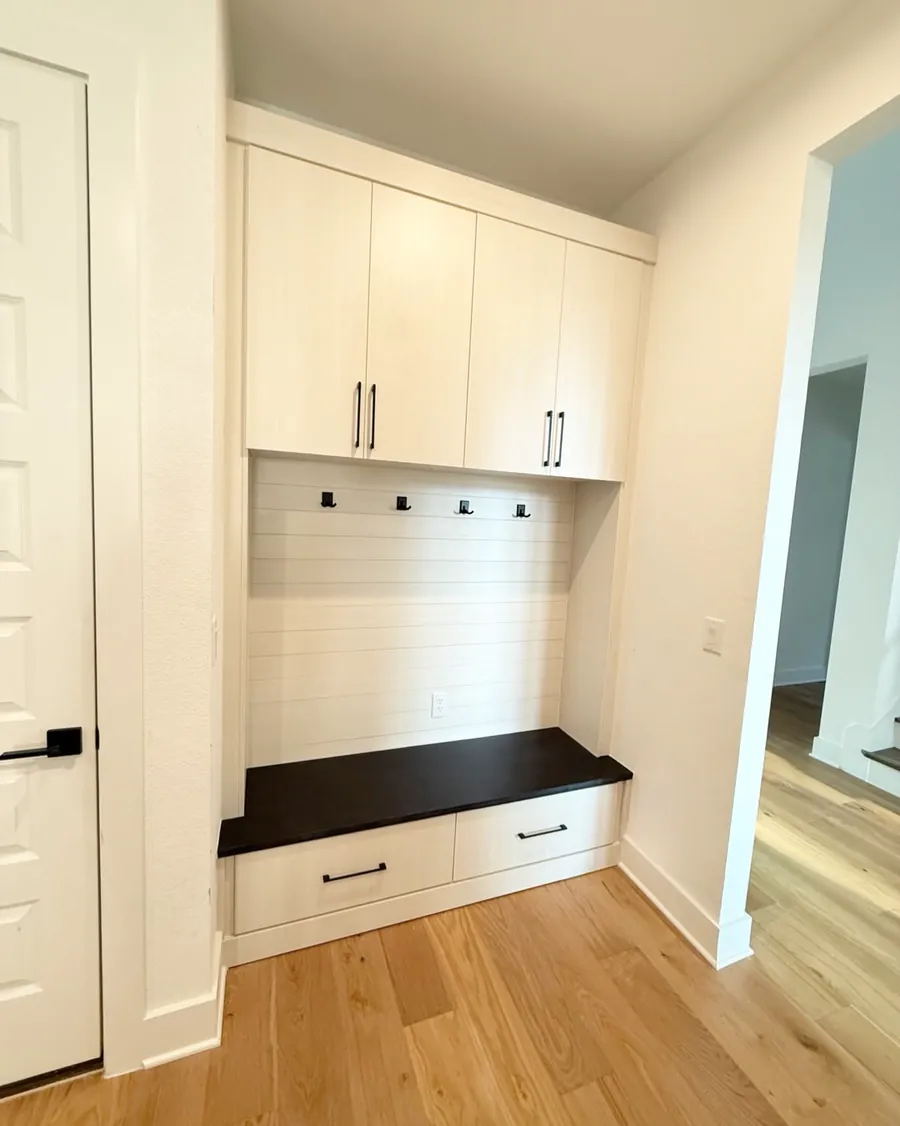 Mudroom bench with hooks, upper cabinets and a drawer under the seat